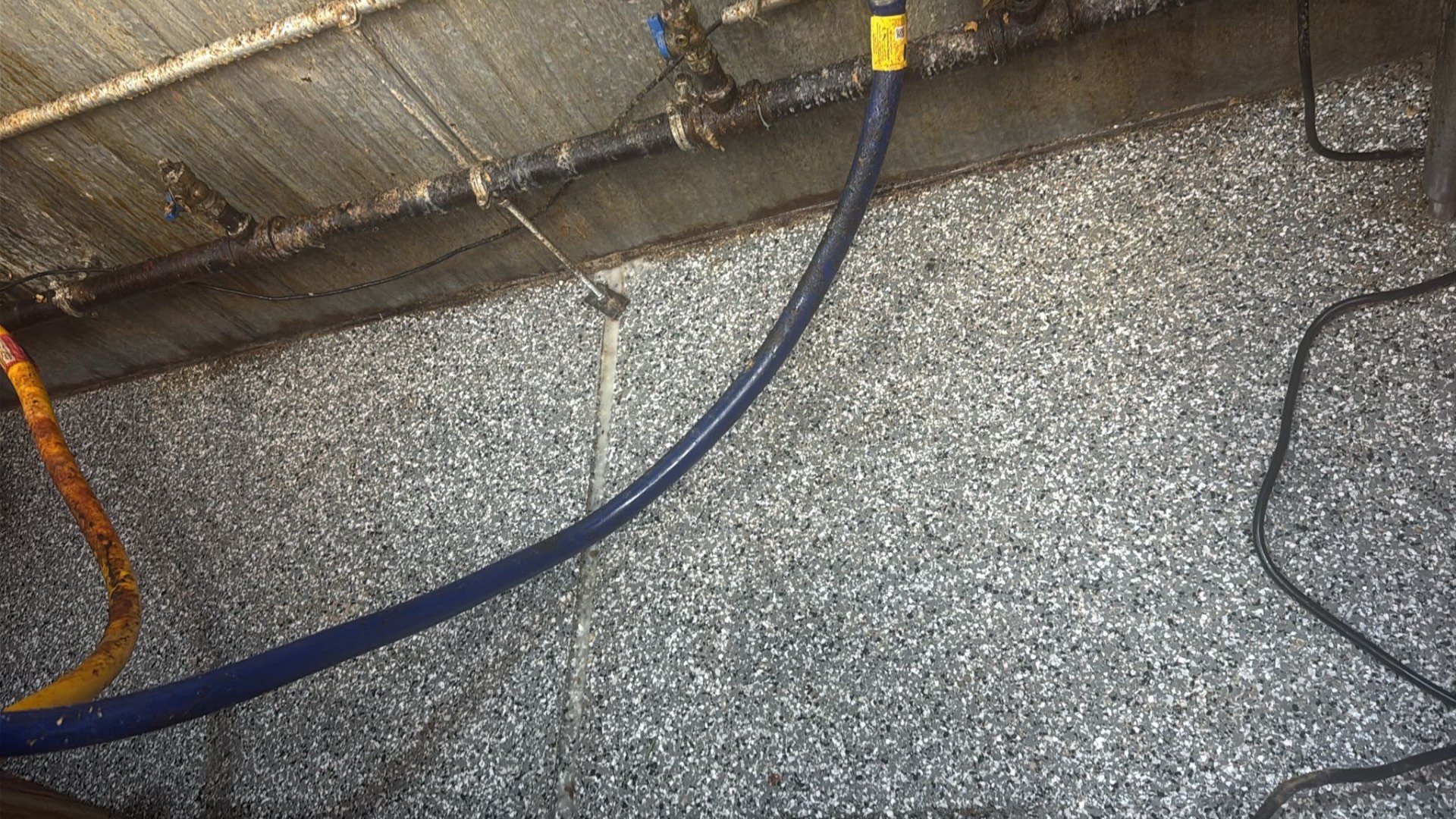Same utility corner and pipe run after Clear Shine deep cleaning